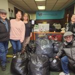 Deacon Bob of Queen of Saints Parish brings in donations from church coat drive